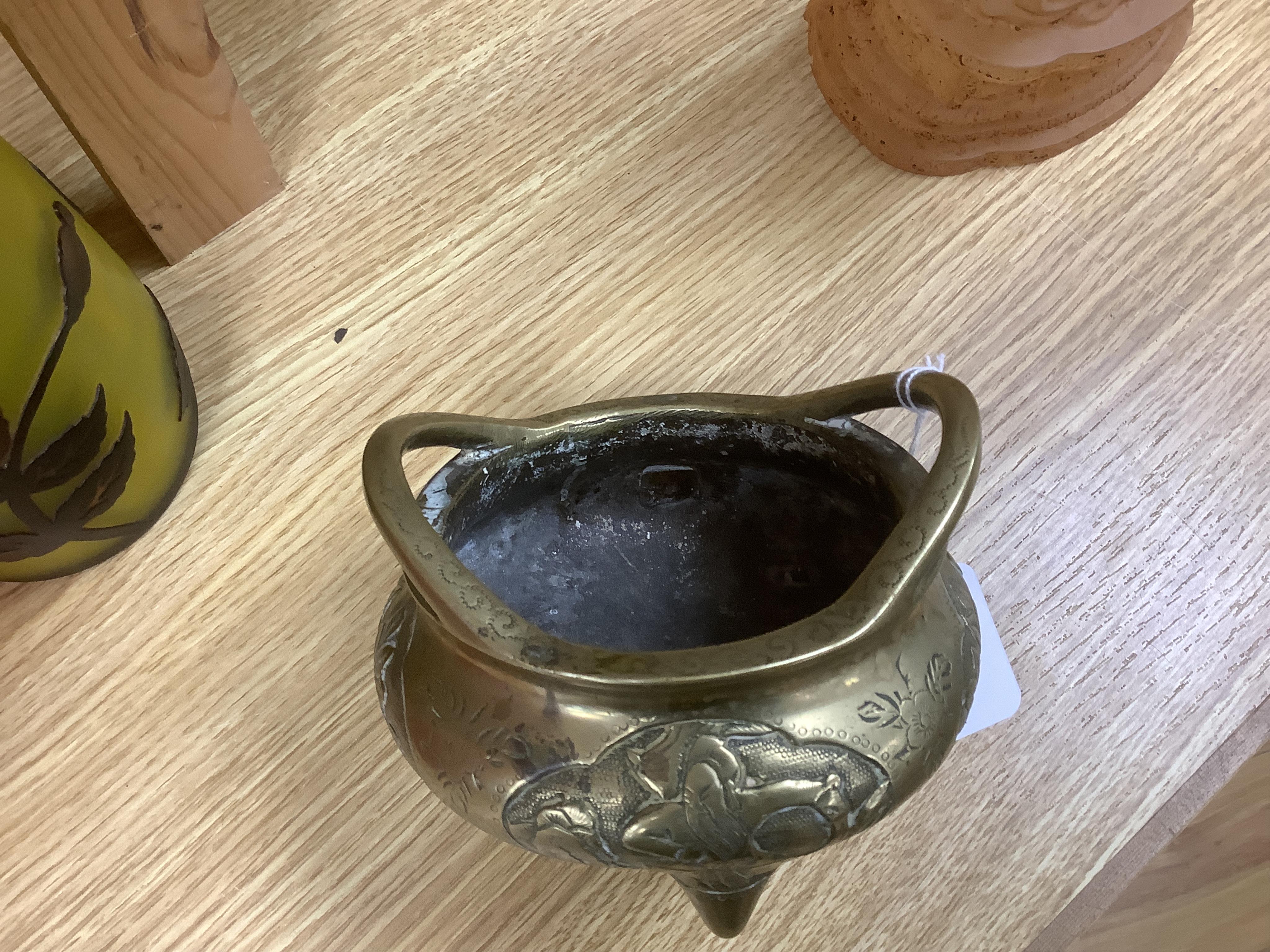 A Chinese bronze tripod censer, Xuande mark, 19th century, 13cm wide. Condition - plug repair to body